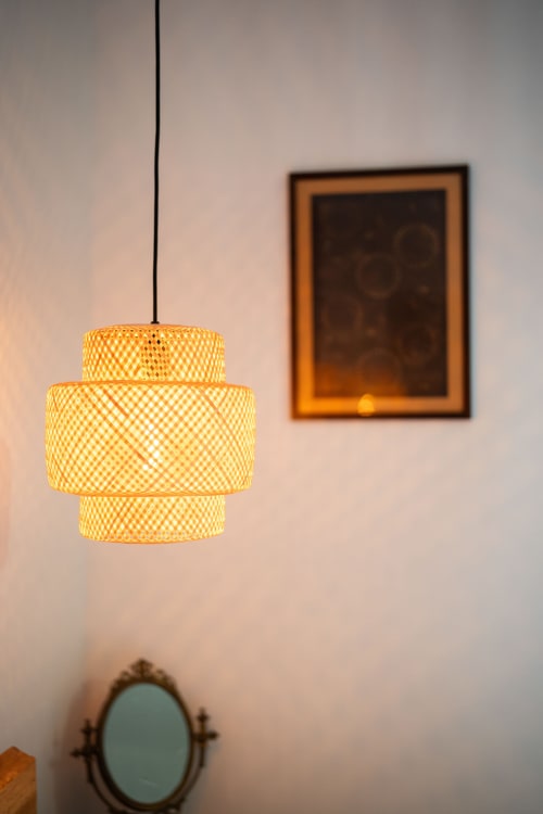 Woven pendant light and framed artwork in Baccara Lodge bedroom, Arengosse boutique accommodation