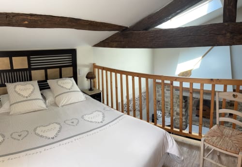 A rustic room with exposed beams at Logis De La Bénétière in Treize-Vents, a former bread oven