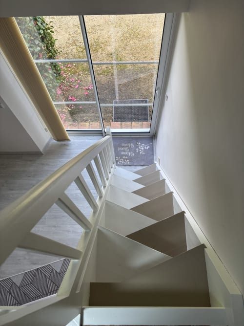 White staircase with garden view at Logis De La Bénétière, Suite du Meunier in Treize-Vents