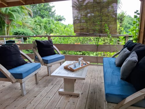 Tropical deck at Le Bougainvillier Blanc with lounge chairs, blue cushions, and jungle views from Bungalow 2