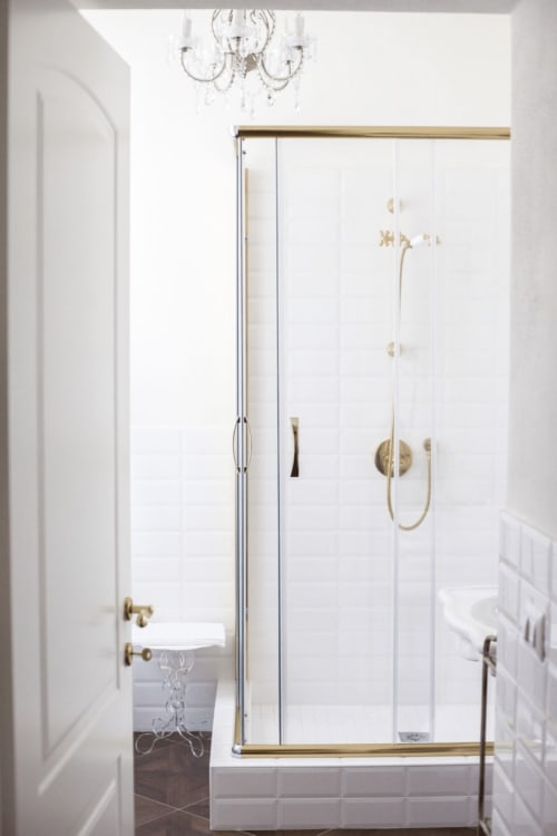 Modern shower enclosure with brass fixtures in Alessia's Place suite, Como