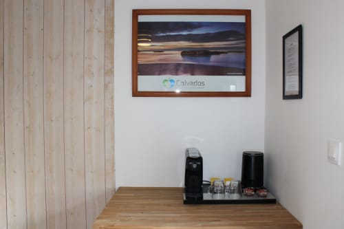 Coffee station in Domaine des Piéris room with framed coastal landscape and kettle