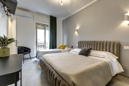 Modern hotel room at Palazzo Belvedere in Chianciano Terme with twin beds, balcony, and contemporary furnishings