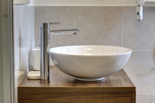 Modern bathroom vanity with white ceramic bowl sink and chrome faucet at Palazzo Belvedere hotel in Chianciano Terme