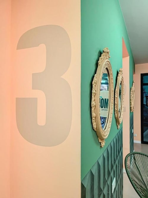 Lemon Hostel Altea hallway with colorful walls, large number 3, ornate gold mirrors, and modern green accent wall