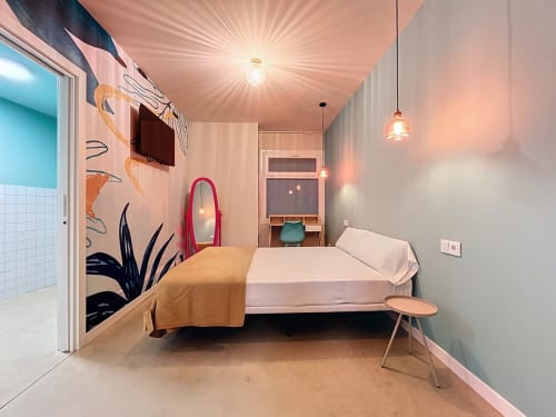 Modern private double room at Lemon Hostel Altea with bed, artistic wall mural, pendant lighting, and ensuite bathroom