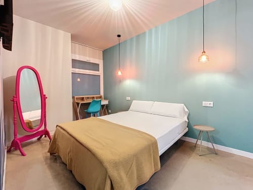 Private double room at Lemon Hostel Altea with turquoise accent wall, pink mirror, and pendant lighting