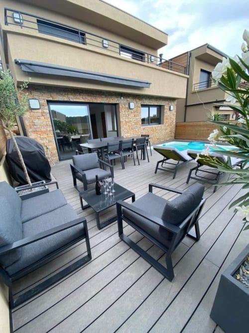Villa Stella terrace with lounge seating, dining table, and pool view at Favone, managed by Corsu di Core conciergerie
