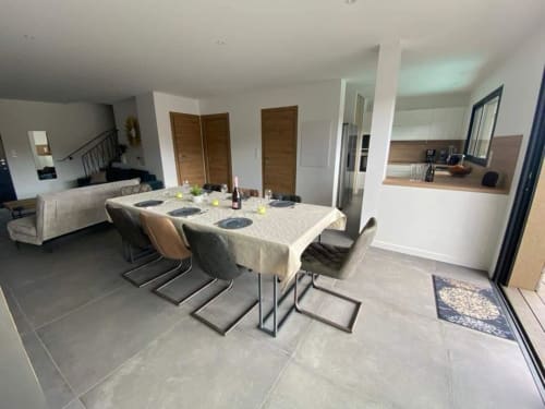 Modern dining area in Villa Stella at Favone with set table and kitchen access, managed by Corsu di Core conciergerie