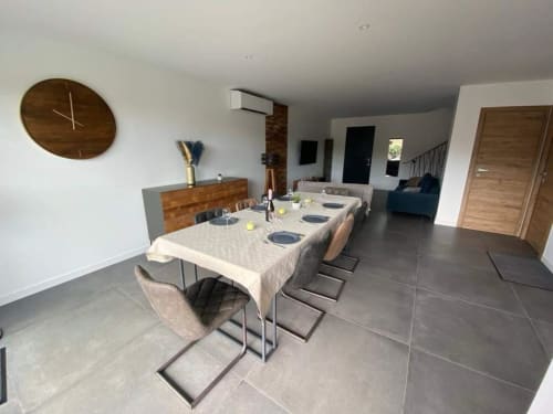 Modern dining room in Villa Stella at Favone, with dining table, wooden buffet, and pool view, managed by Corsu di Core conciergerie