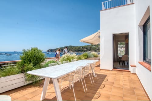Beachfront apartment terrace in Palafrugell with dining table, sea views, and direct beach access