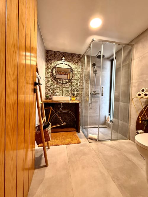 Casa de banho moderna com duche walk-in, móvel de madeira e parede de azulejos decorativos na Kindnessmoon em Óbidos, Portugal