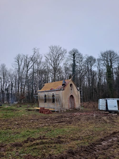Villa de style chapelle en construction au Château de la Malmaison, Aÿ-Champagne, entourée d'arbres nus d'hiver