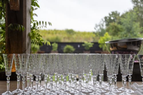 Crystal wine glasses displayed outdoors at Domaine du Tertre Ychot in Dol de Bretagne, France