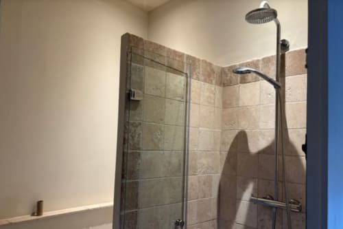 Modern shower with rainfall showerhead and hand sprayer in Courtyard Apartment bathroom, Lourmarin village