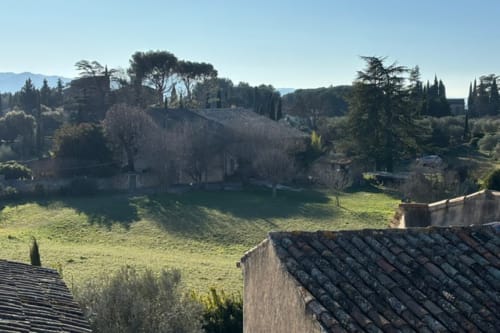 Lourmarin château and rolling Provence landscape with terrace and cypress trees at Ancienne Maison des Gardes