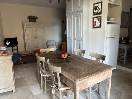 Spacious dining area with wooden table and chairs, kitchen, and living space in The Music Room apartment at Ancienne Maison