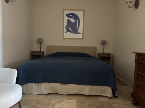 Spacious bedroom in The Music Room studio at Ancienne Maison des Gardes, Lourmarin, with blue bedding, neutral walls, and