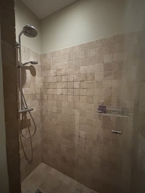 Modern shower stall with rainfall showerhead and hand spray in The Music Room at Ancienne Maison des Gardes, Lourmarin