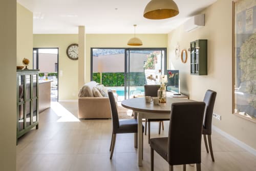 Modern villa dining area with pool view, elegant furniture and bright space, managed by Corsu di Core conciergerie