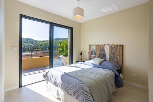 Bedroom with sea view balcony at Villa Oia, in Favone, Corsica, managed by Corsu di Core