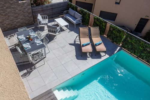 Aerial view of Villa Oia's heated pool with lounge chairs, dining table, and seating area at Favone, managed by Corsu di Core