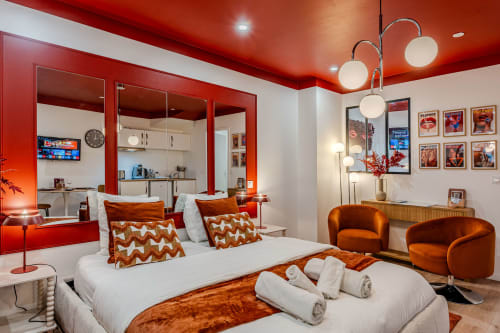 Red and white modern bedroom at Wellkhome Bordeaux with orange accents, city views, and contemporary furnishings