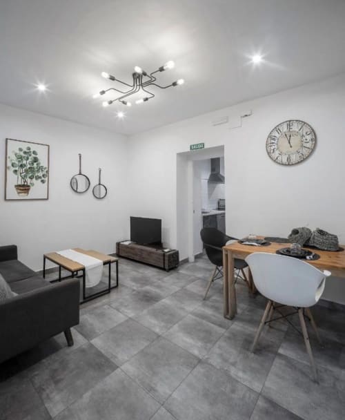 Apartamento moderno en Mérida con comedor, sala de estar, cocineta y muebles contemporáneos bajo techo geométrico