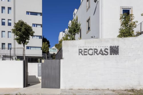 Regras Apartments & Garden entrance in Porto, Portugal with modern white buildings and landscaping