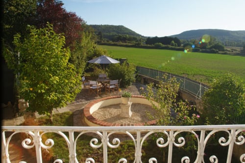 Scenic garden terrace at Les Gîtes de l'Impériale in Sermizelles with seating area, fire pit, and countryside views