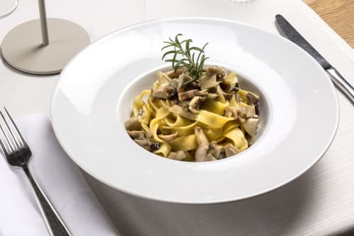 Tagliatelle pasta with mushrooms and rosemary garnish at Palazzo Belvedere, Chianciano Terme