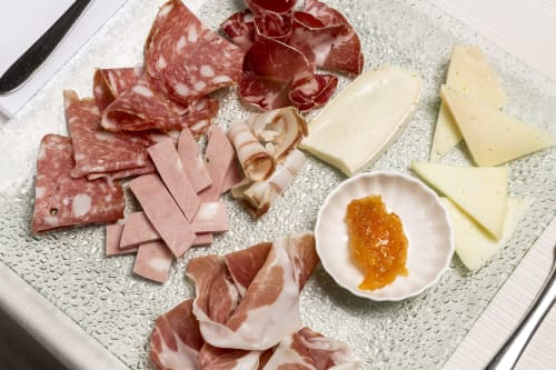 Charcuterie board with cured meats, cheese, and jam at Palazzo Belvedere hotel in Chianciano Terme