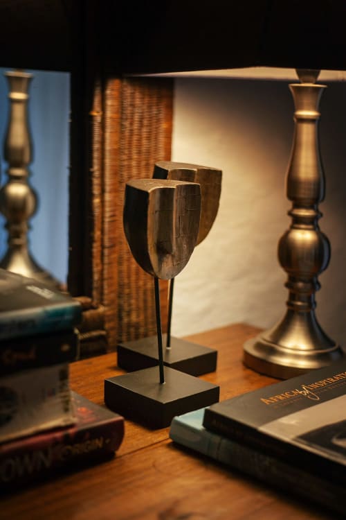Elegant wooden sculptures and brass candlesticks on display at Alombre B&B in Lectoure, France