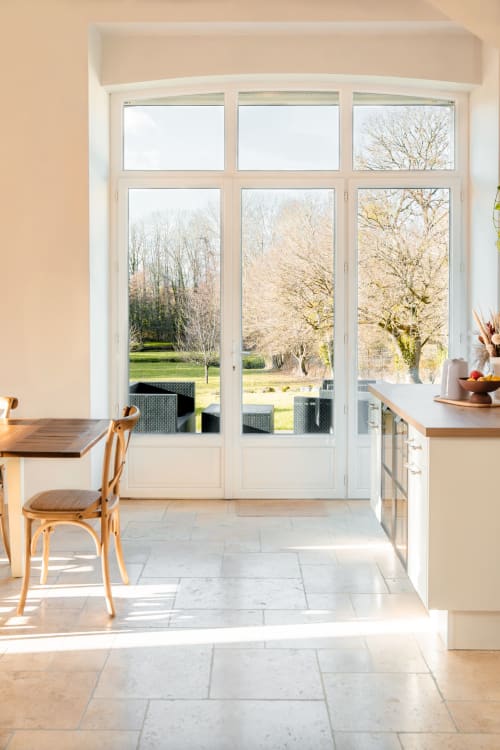 View from the living area at Le Logis — outdoor terrace overlooking a 1-hectare garden with a private river and pond, perfect for a nature-filled stay near Blois
