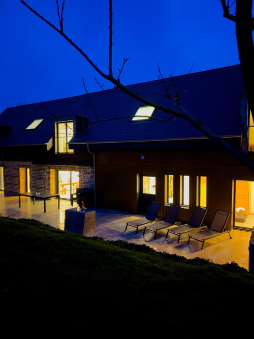 The large holiday home La Moussette for 12 people, seen from the orchard at night
