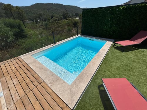 Crystal blue heated swimming pool at Corail villa in Favone with loungers and hillside views, managed by Corsu di Core