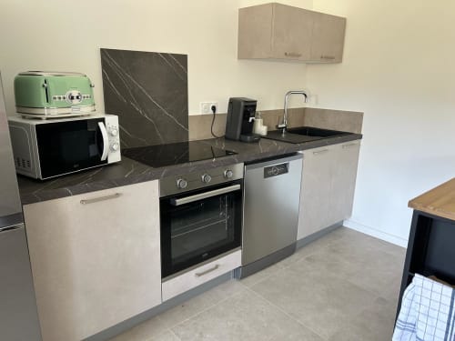 Modern equiped kitchen in Villa Corail  with marble countertops, stainless steel appliances, managed by Corsu di Core