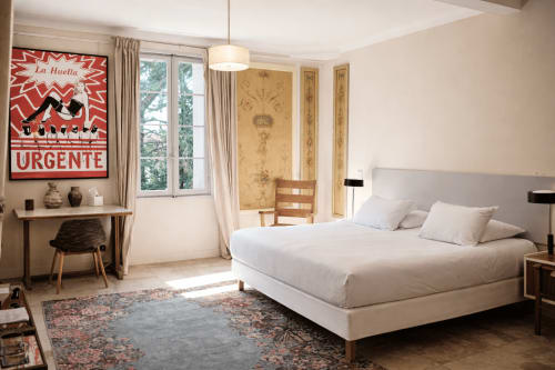 Bright bedroom at Mas De Lafeuillade B&B in Montpellier with queen bed, vintage decor, and garden views