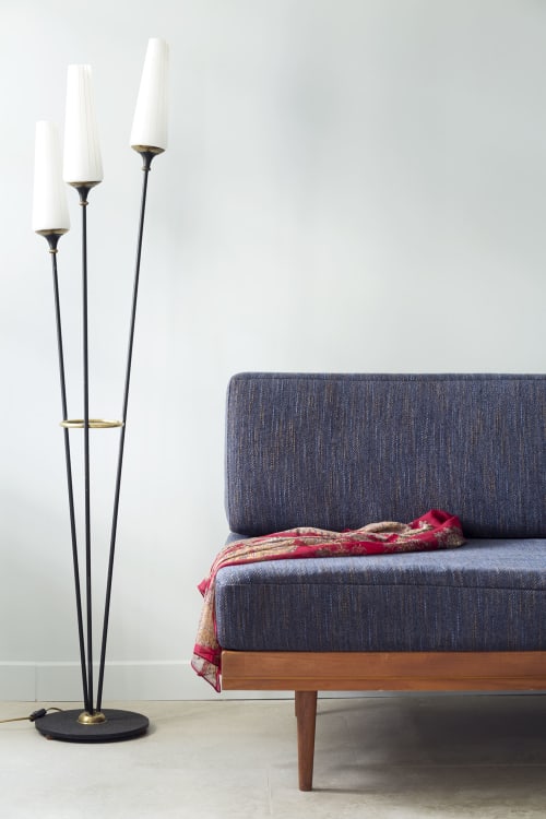 Modern bedroom at Mas De Lafeuillade with grey upholstered bed, wooden frame, and contemporary floor lamp with white shades