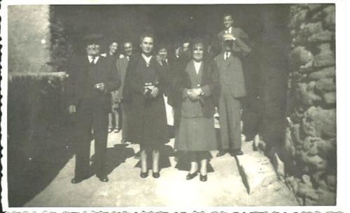Grupo de huéspedes formalmente vestidos de pie en el interior de la casa rural Can Gat Vell en Girona, Cataluña