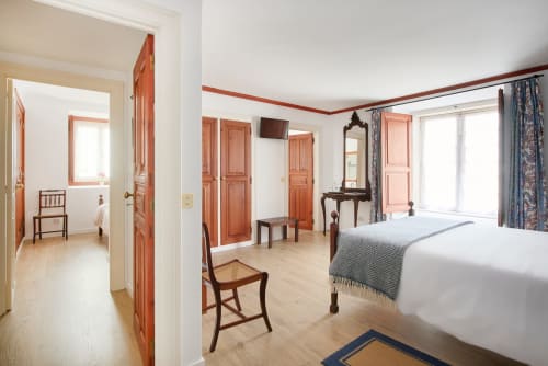 Spacious bedroom at Quinta da Alcaidaria-Mór near Fátima with twin beds, wooden furniture, and traditional décor
