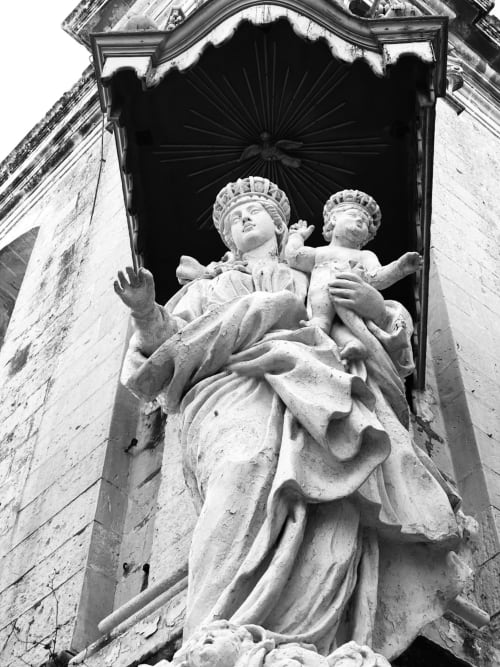 Stone statue of woman with children at Le Prieuré Du Preux in Sépeaux Saint Romain, France