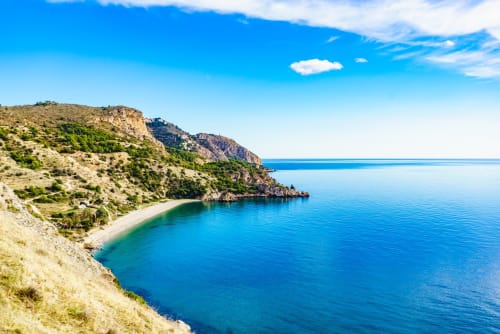 Costa mediterránea pristina con playa de arena y acantilados rocosos cerca de Málaga, España