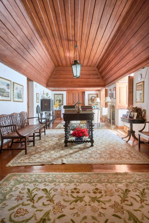 Elegant wooden music room at Quinta da Alcaidaria-Mór in Fátima with grand piano, classical furniture, and traditional décor
