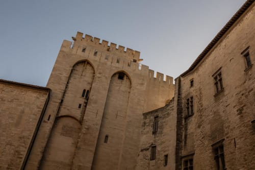 Medieval stone castle tower with crenellations at Le Prieuré Notre-Dame, Montfrin, France