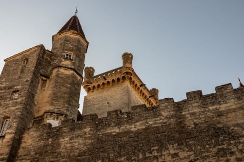 Medieval stone castle towers at Le Prieuré Notre-Dame, a charming bed and breakfast in Montfrin, France
