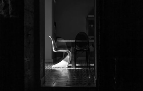 Modern white chair at dining table in Le Prieuré Notre-Dame, a boutique B&B in Montfrin, France