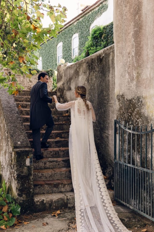 Couple climbing historic stone steps at Quinta da Alcaidaria-Mór in Ourém-Fátima, Portugal
