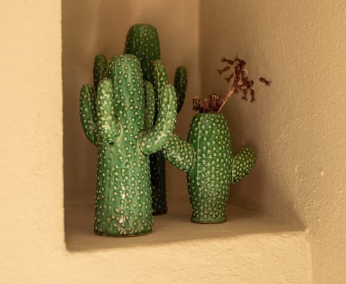 Green ceramic cacti sculptures displayed in alcove at Le Prieuré Notre-Dame, Montfrin