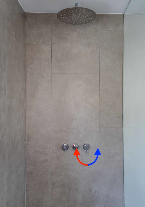 Modern shower enclosure at Star Host with rainfall showerhead and temperature control valves in Bordeira, Portugal